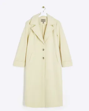 Yellow longline coat with button front.