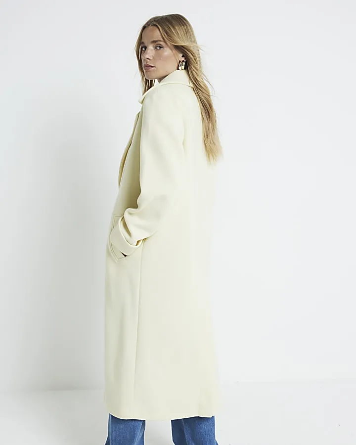 Yellow longline coat with button front.