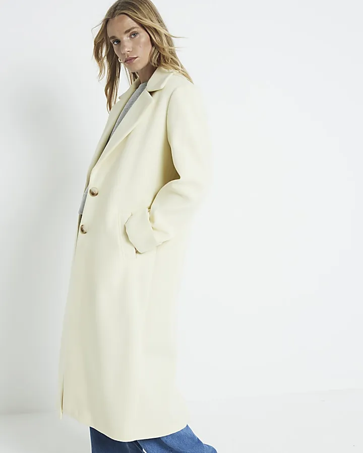 Yellow longline coat with button front.